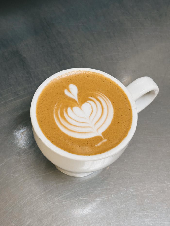 a cup of cappuccino with tulip pattern